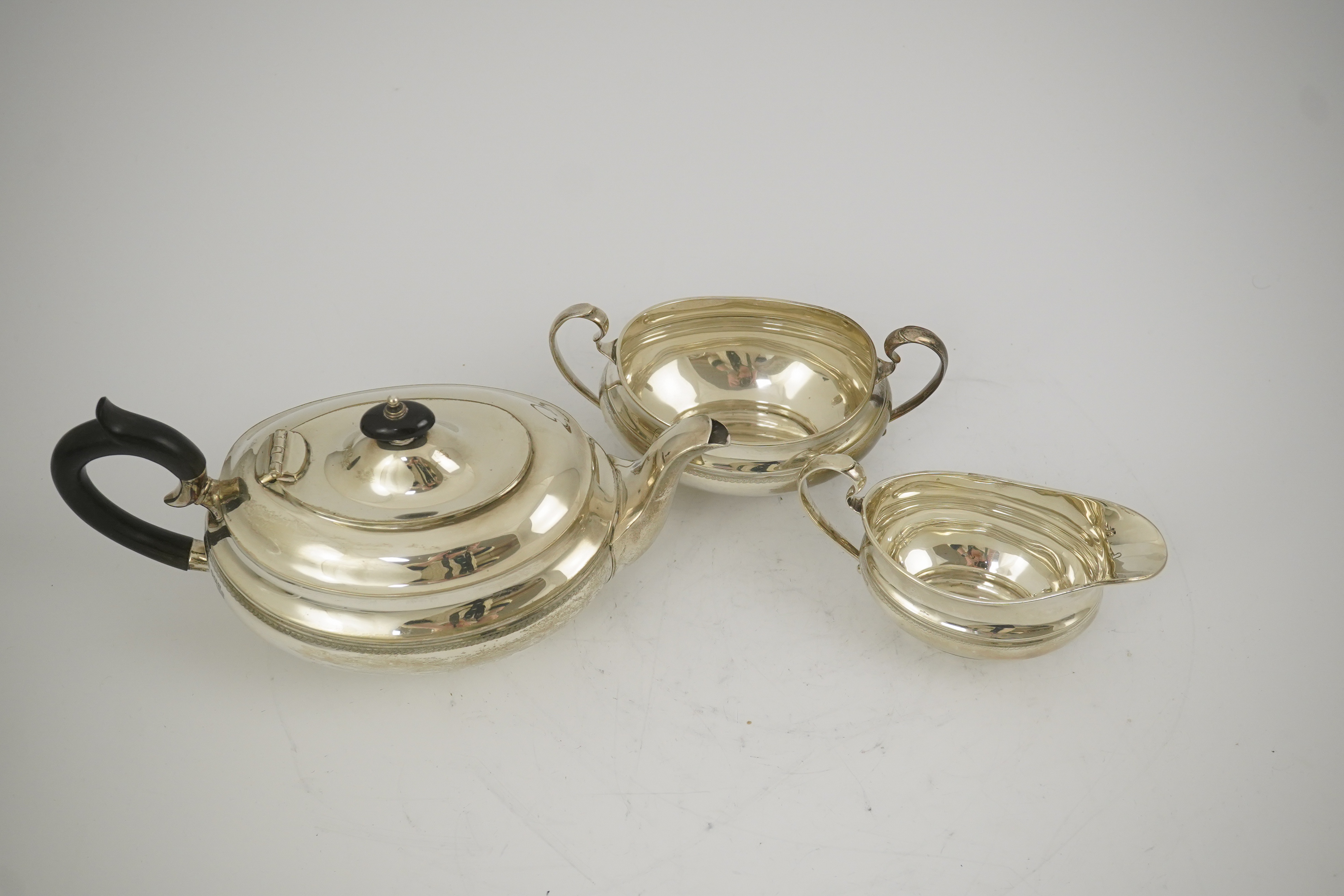 A George V silver three piece oval tea set, by Viners Ltd